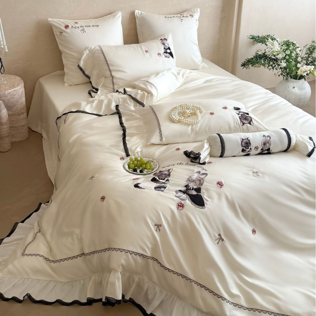Embroidered satin bedding set with frill, ruffled hem, and animal motif