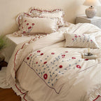 Bedding set made of cotton with floral embroidery and playful ruffle hem