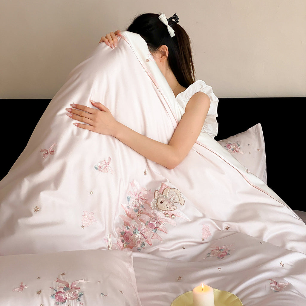 Romantic bedding set made of fine cotton satin with delicate embroidery and decorative cushion