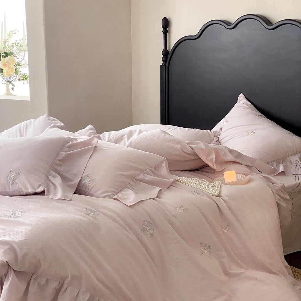 Vintage-inspired linen bedding set with fine rose embroidery and soft wash finish