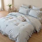 Satin bedding set with ruffles, embroidered bunny appliqués and silky-smooth finish