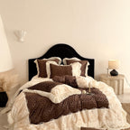 Opulent quilted bedding set with leopard pattern, ruffle trim and decorative embroidery