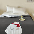 Reversible quilted bedspread with embroidered bear motif and light filling