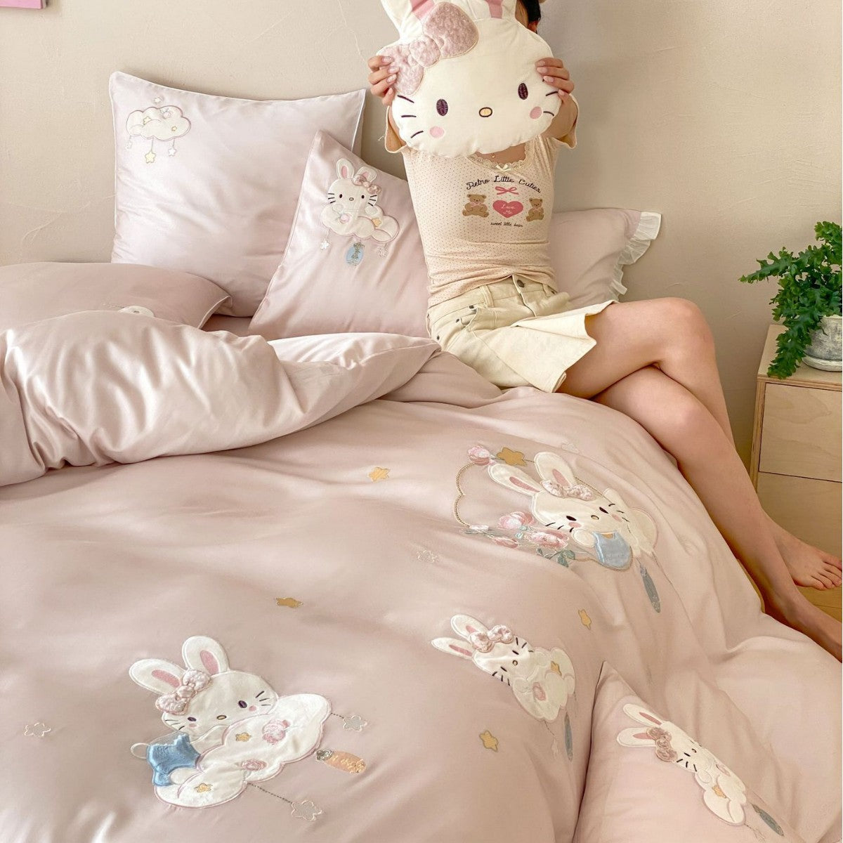 Playful children's bedding set made of silky-soft cotton satin with appliquéd bunnies and cuddly pillow