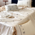 Fine silk look cotton satin bed linen set with delicate ribbon embroidery and ties