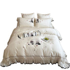 Embroidered satin bedding set with frill, ruffled hem, and animal motif