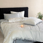 Cotton satin bedding set with delicate floral embroidery and lace trim