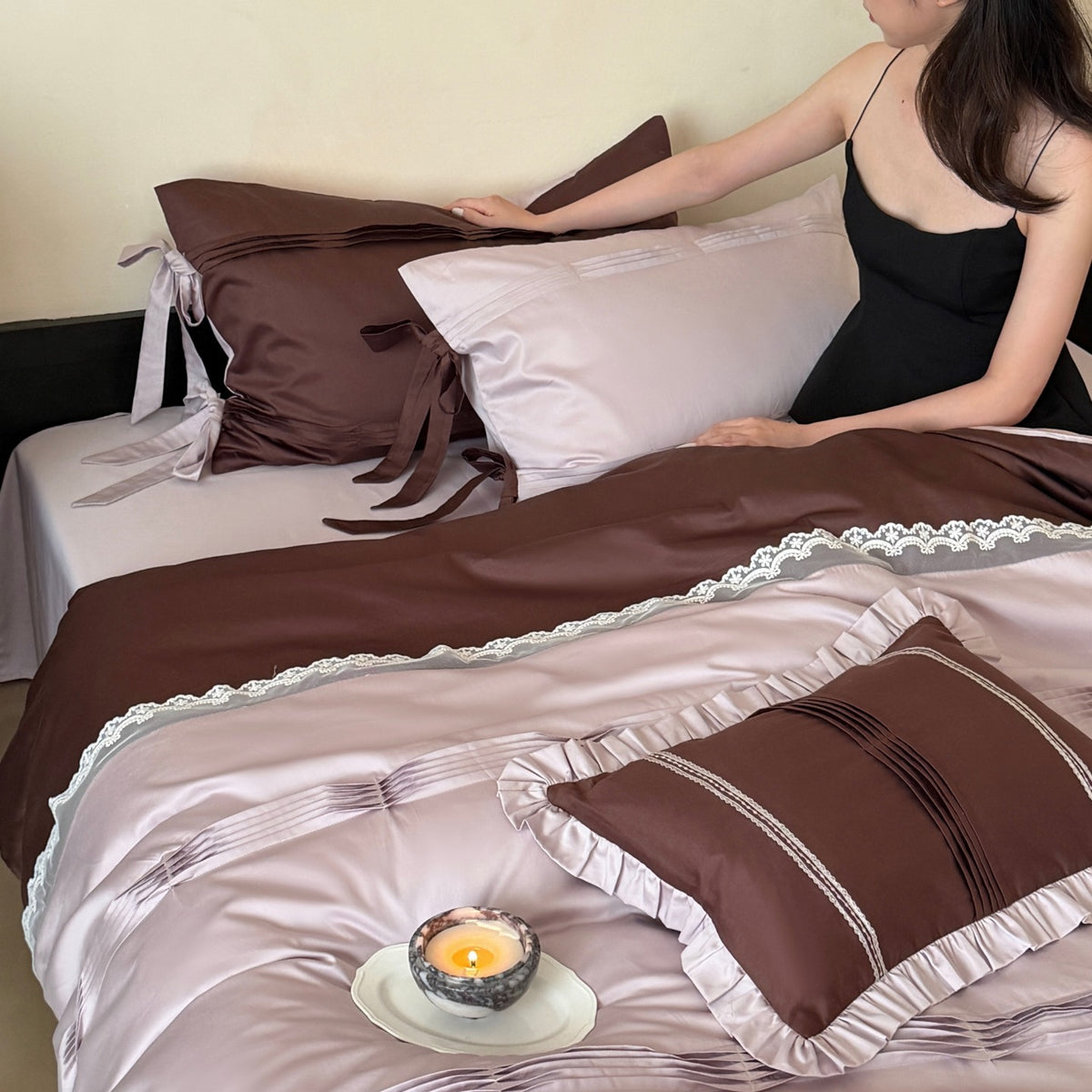 Elegant bedding set made of cotton satin with decorative pleats, bows, and lace trim
