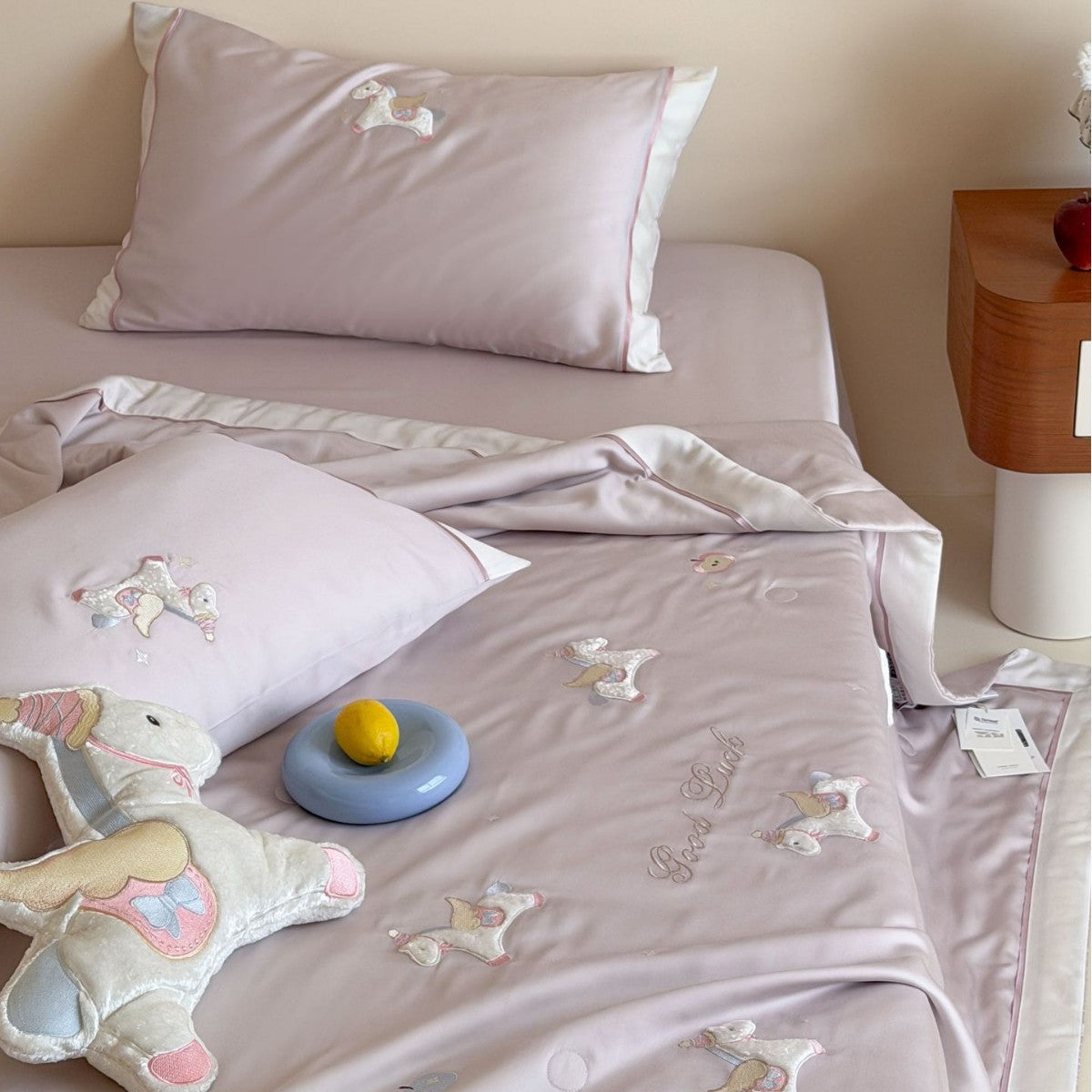 Satin bedding set with embroidered cat appliqués and silky soft finish
