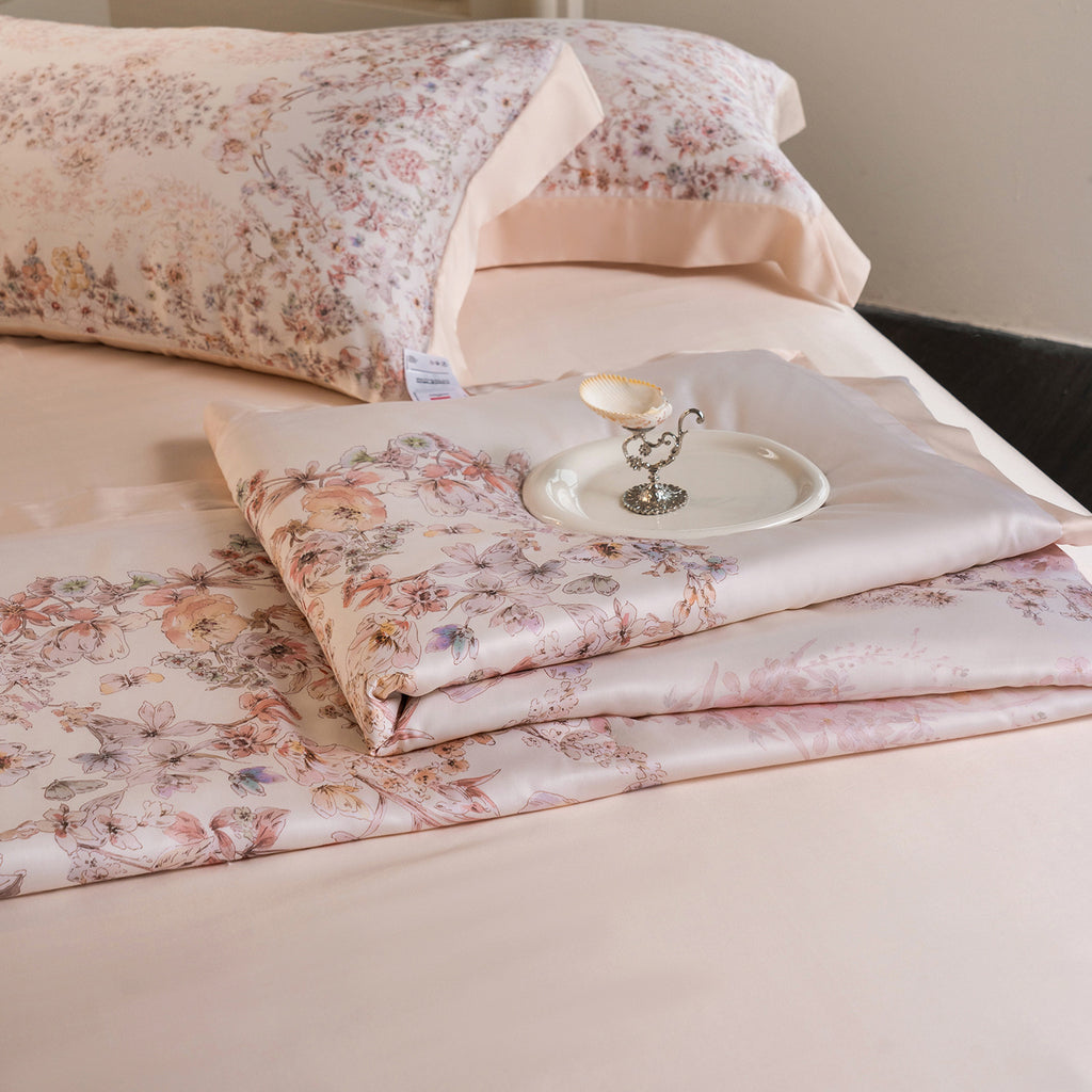 Luxurious cotton satin bed linen set with delicate floral print and quilted bedspread