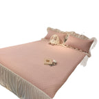 Quilted bedspread with ruffle and delicate floral quilting