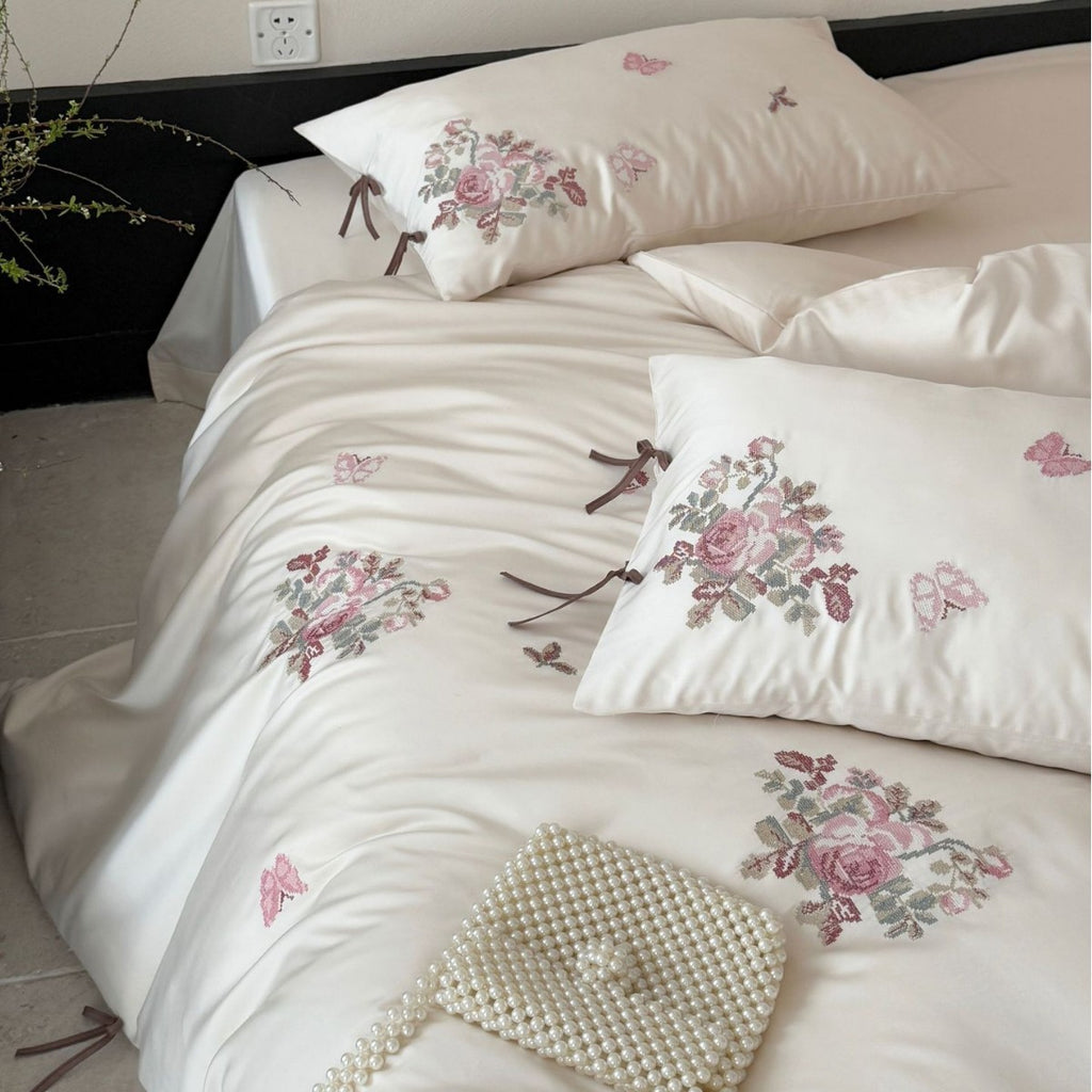 Silky-matte satin bedding set with embroidered rose bouquets and ties