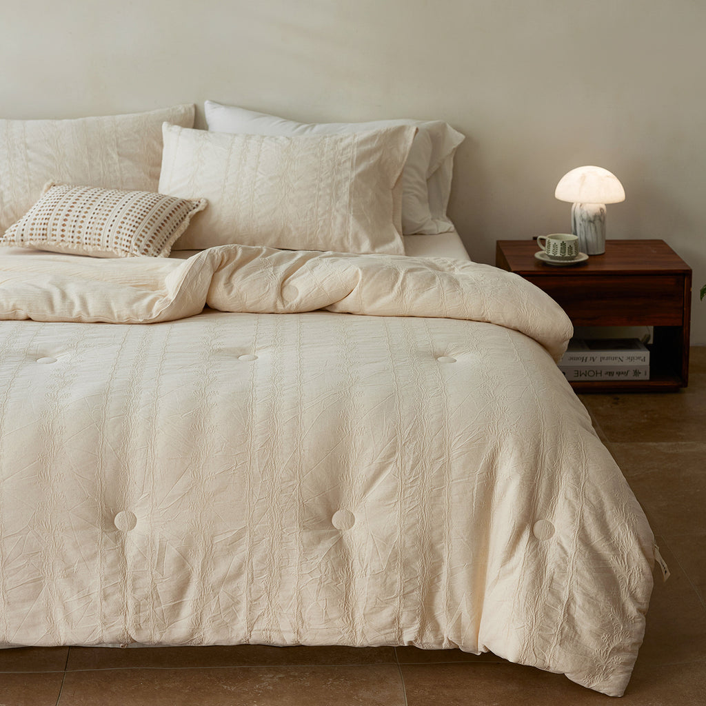 Quilted duvet cover made of linen-cotton mix with subtle textured embroidery and button tufting