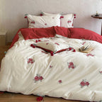 Embroidered cotton bedding set with rose appliqués and tassels