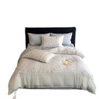 Cotton satin bedding set with delicate floral embroidery and lace trim