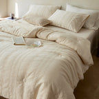 Quilted duvet cover made of linen-cotton mix with subtle textured embroidery and button tufting
