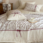 Luxurious cotton satin duvet cover set with lace trim, floral all-over embroidery, and decorative ribbons