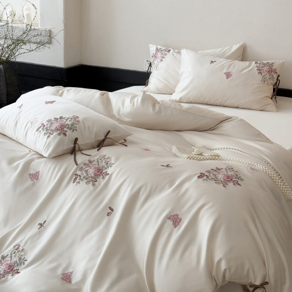 Silky-matte satin bedding set with embroidered rose bouquets and ties