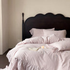 Vintage-inspired linen bedding set with fine rose embroidery and soft wash finish