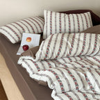 Breathable cotton bedding set with striped floral border and fitted sheet