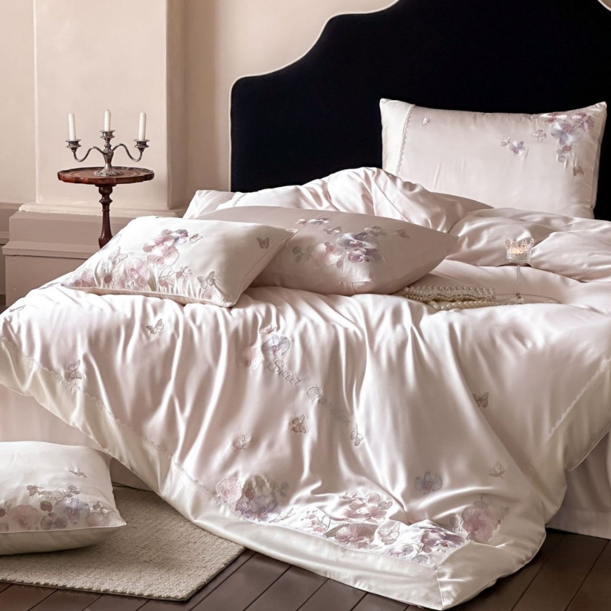 Luxurious satin bedding set with floral embroidery and butterfly appliqué