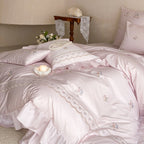 Luxurious cotton satin bedding set with floral embroidery, ruffle and decorative pillow