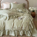 Elegant bedding set made of cotton satin with ruffles, delicate floral embroidery, and frills