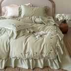 Elegant bedding set made of cotton satin with ruffles, delicate floral embroidery, and frills