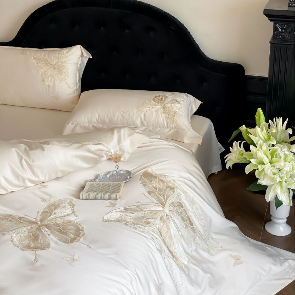 Luxurious satin bedding set with embroidered butterfly motifs and silky glossy finish