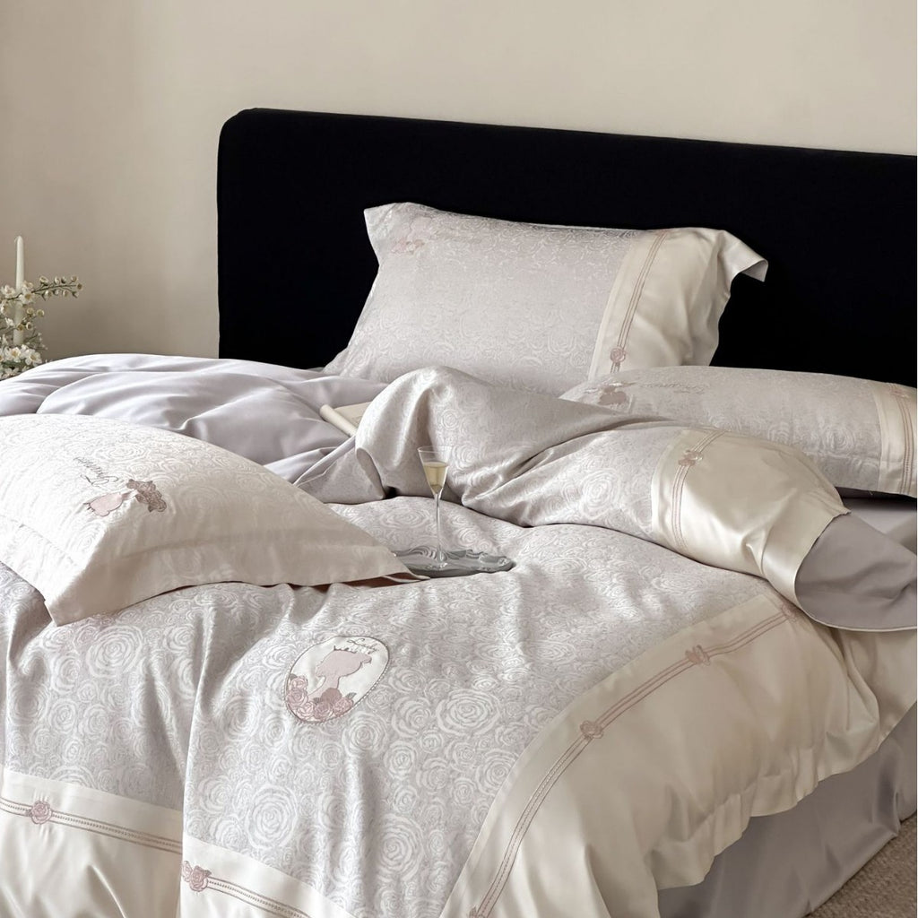 Luxurious cotton satin bed linen set with jacquard rose pattern and embroidered silhouette applications