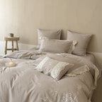 Vintage-inspired linen-cotton blend bedding set with floral chain stitch embroidery and lace trim