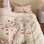 Bedding set made of cotton with floral embroidery and playful ruffle hem