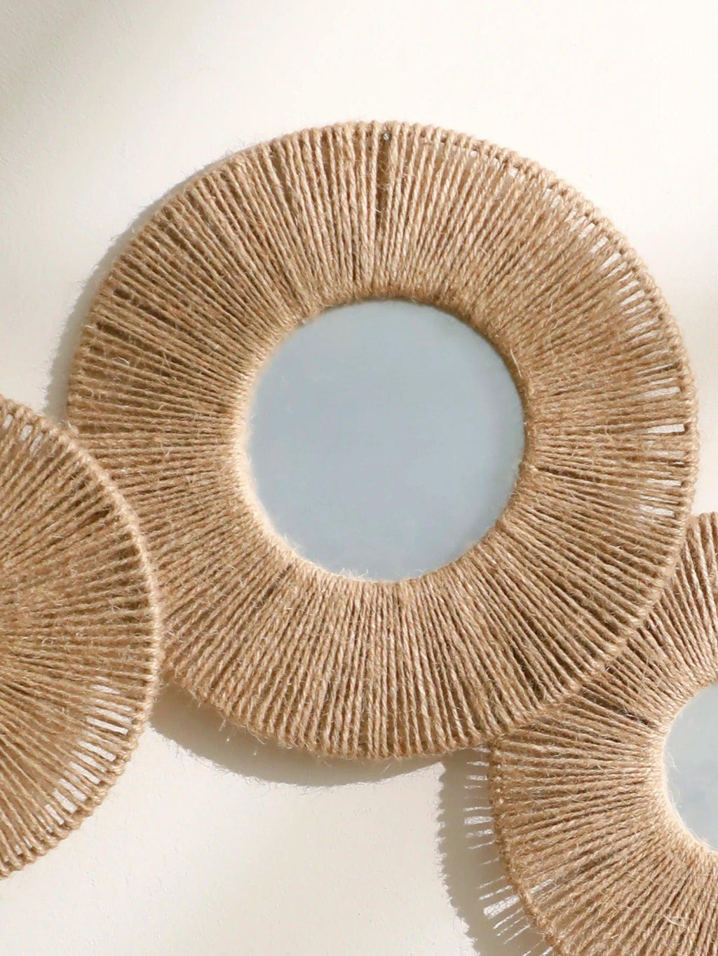 Round decorative wall mirror in boho style with woven hemp rope