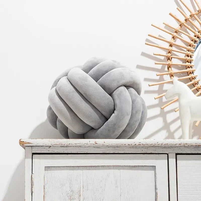 Decorative, soft cushion with knotted ball in suede look